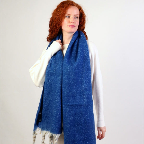 Woman wearing a blue scarf with white background